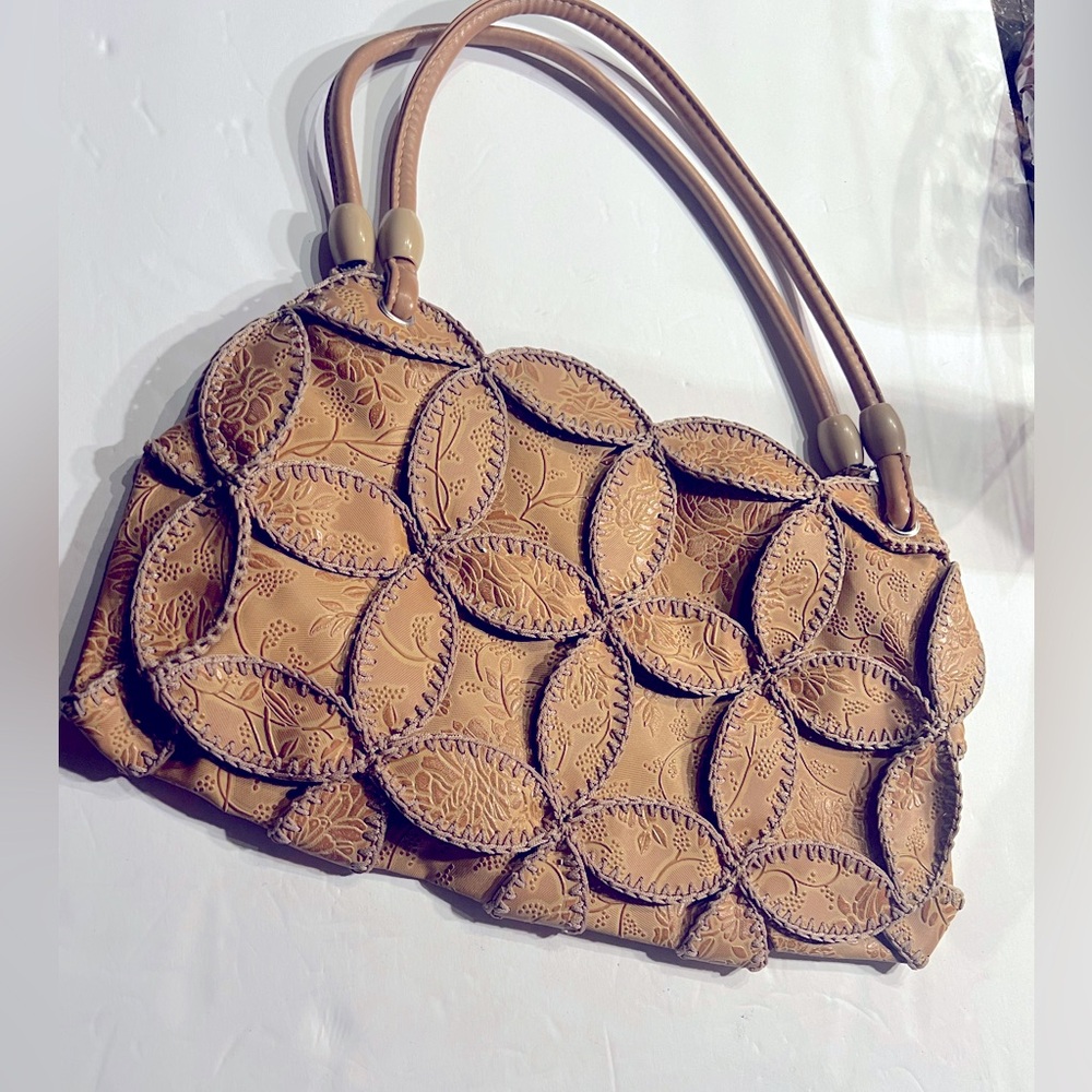 Light Brown Boho purse with leaf patchwork and wooden beads on handles.